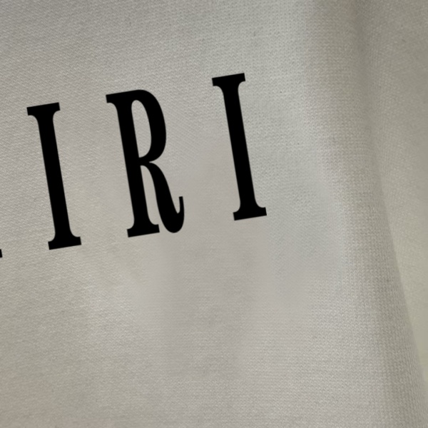AMIRI アミリ ロングTシャツ メンズ レディース ロゴプリント 長袖Tシャツ クルーネック シンプル 無地風 ストリート ユニセックス