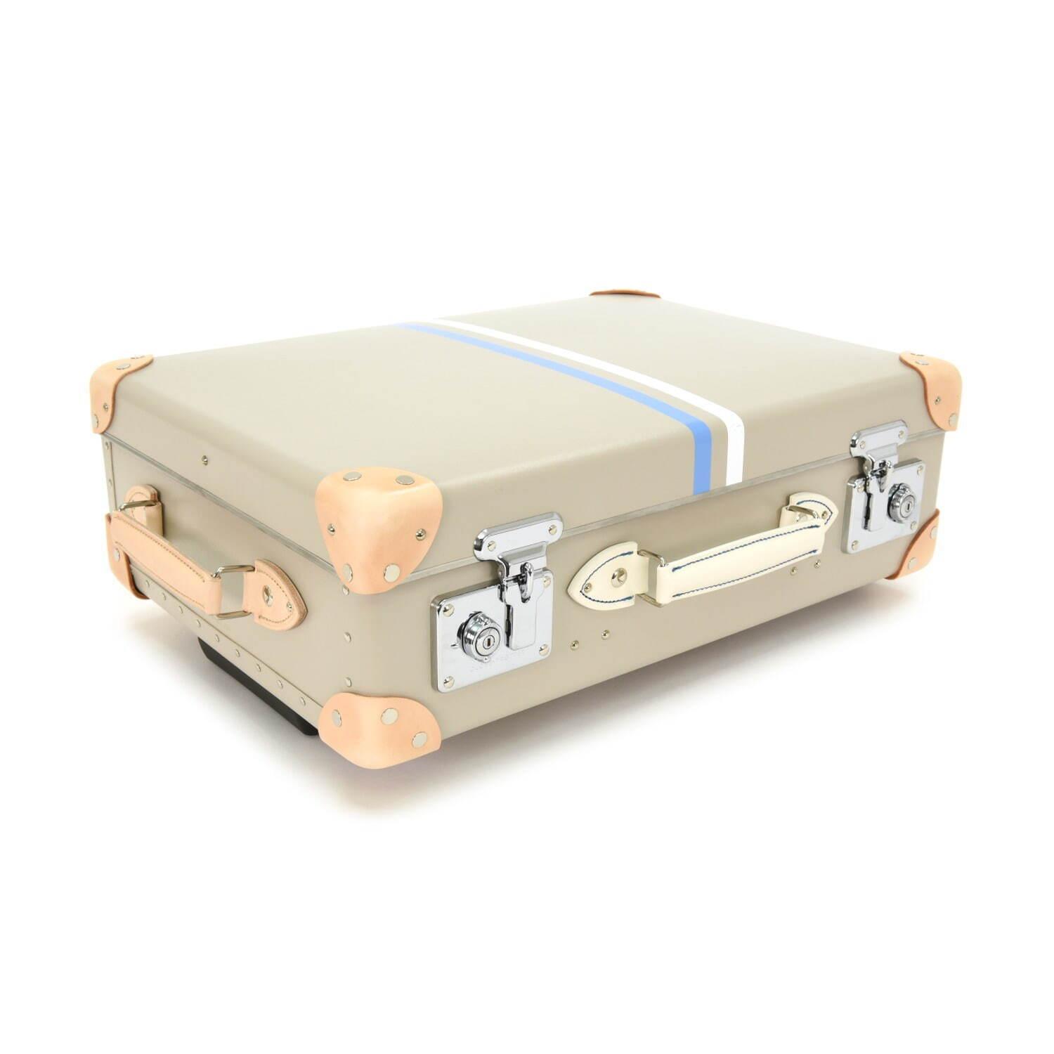 グローブ・トロッター“英国の家族旅行”着想のストライプ柄スーツケース、白い砂浜×青い海カラー コピー